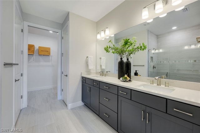 bathroom featuring an enclosed shower and vanity