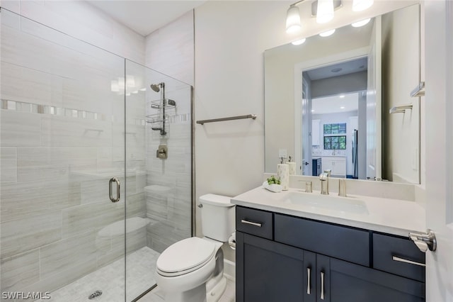 bathroom featuring vanity, toilet, and an enclosed shower