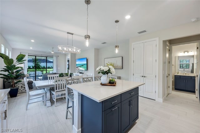 kitchen with a kitchen island, hanging light fixtures, and a breakfast bar area