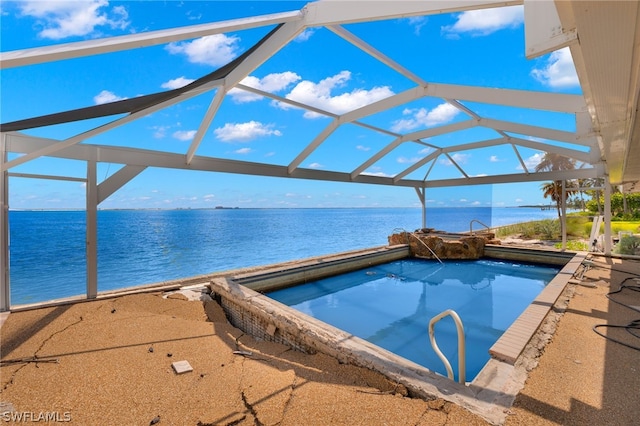 view of swimming pool with glass enclosure, a water view, and a jacuzzi