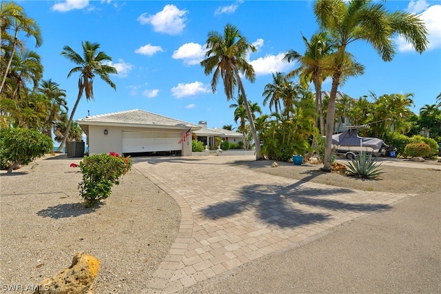 view of front of home featuring a garage and central AC