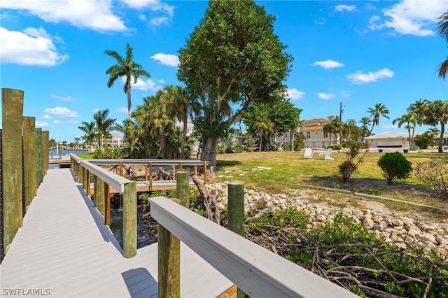 view of dock with a lawn