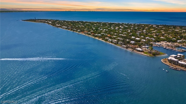 aerial view at dusk with a water view