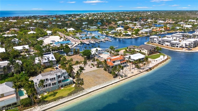 birds eye view of property with a water view and a view of the beach