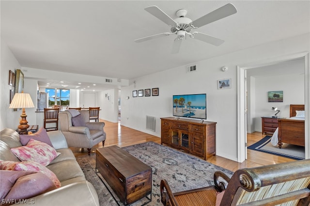 living room with ceiling fan and light hardwood / wood-style floors