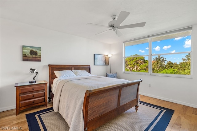 bedroom with ceiling fan and light hardwood / wood-style flooring