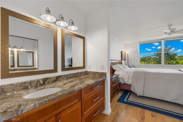 bathroom with ceiling fan, vanity, and hardwood / wood-style flooring