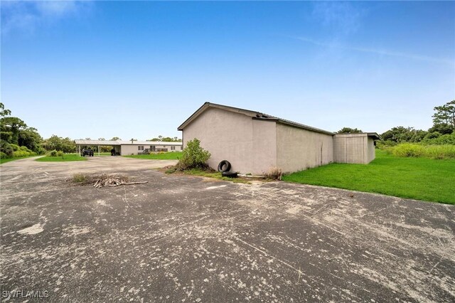 view of side of property with a lawn