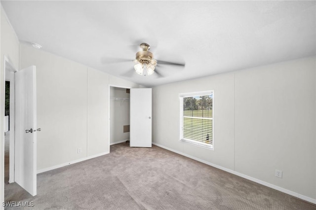 unfurnished bedroom featuring light carpet, a closet, and ceiling fan