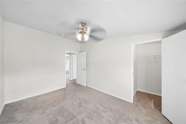 unfurnished bedroom with light carpet, ceiling fan, and a closet