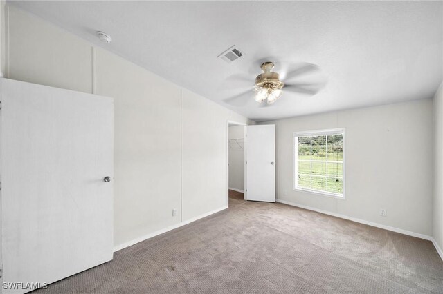 spare room featuring ceiling fan and carpet flooring