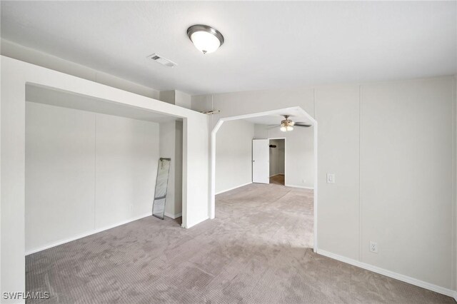 carpeted spare room featuring ceiling fan