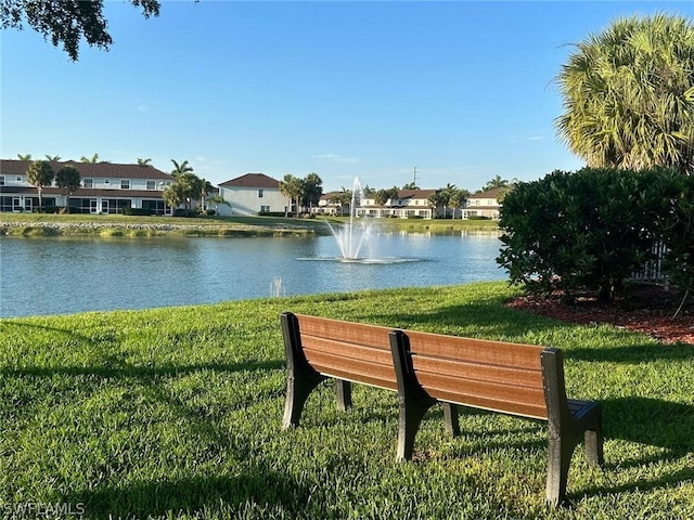 view of property's community with a residential view, a water view, and a yard
