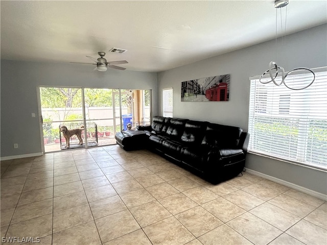 tiled living room featuring ceiling fan