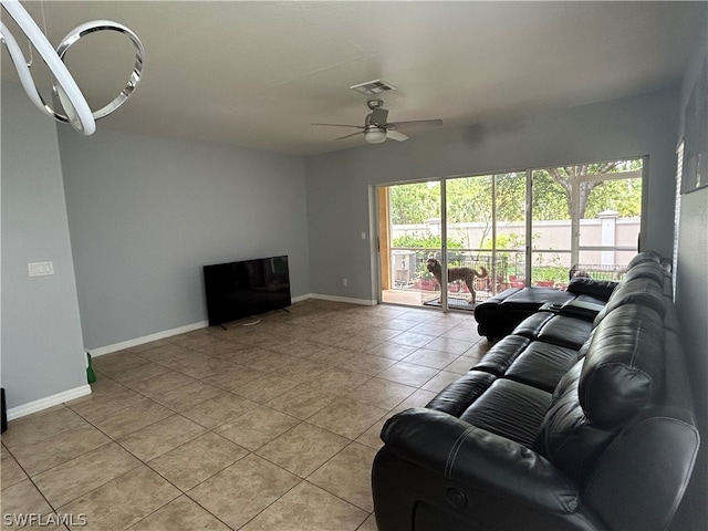 living room with ceiling fan and light tile flooring