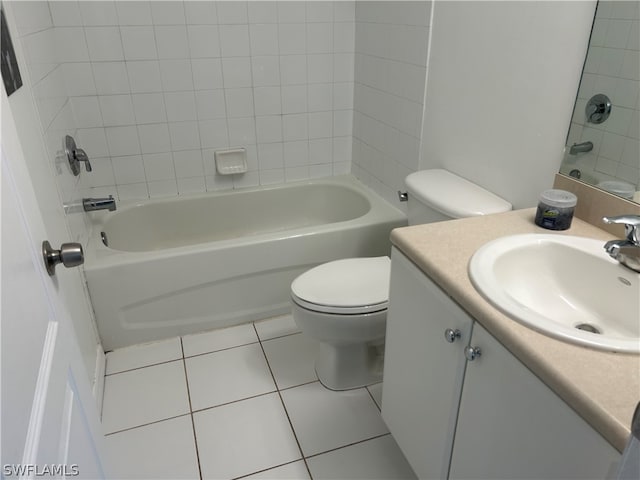 full bathroom with tiled shower / bath combo, vanity, toilet, and tile floors