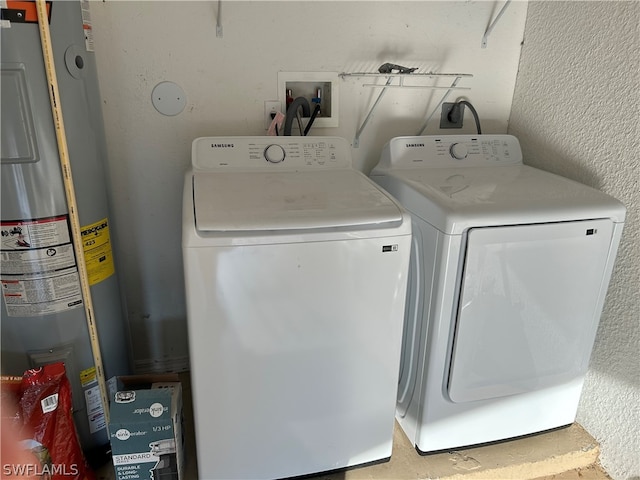 laundry area featuring electric dryer hookup, hookup for a washing machine, electric water heater, and washing machine and dryer