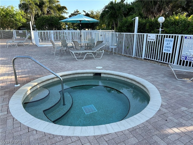 view of swimming pool featuring a community hot tub and a patio area