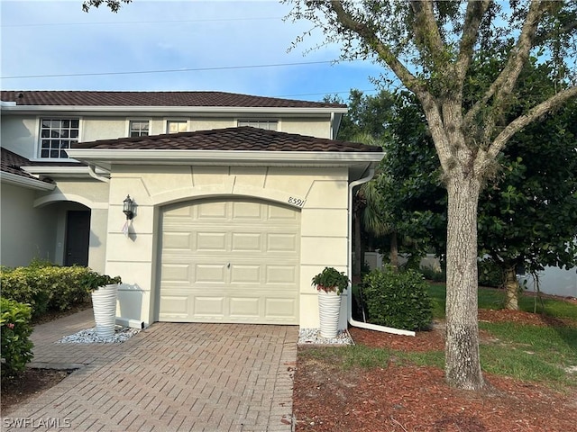 garage with decorative driveway