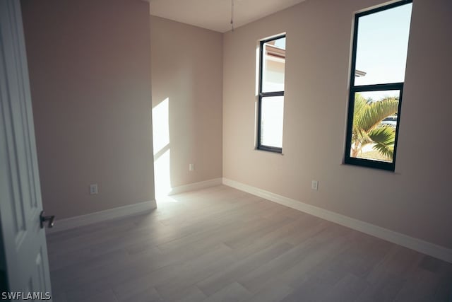 unfurnished room with hardwood / wood-style flooring