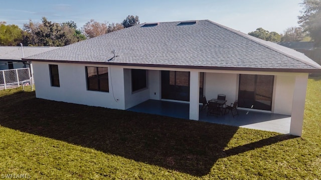 rear view of house with a yard and a patio area