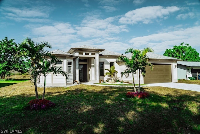 prairie-style house featuring a front yard and a garage