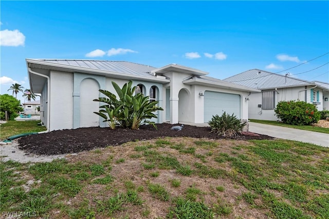 12235 Moon Shell Dr, Matlacha Isles, FL 33991 - ranch-style home featuring stucco siding, concrete driveway, an attached garage, and metal roof