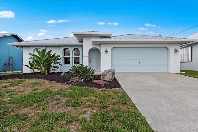 12235 Moon Shell Dr, Matlacha Isles, FL 33991 - ranch-style house featuring stucco siding, driveway, an attached garage, and a standing seam roof