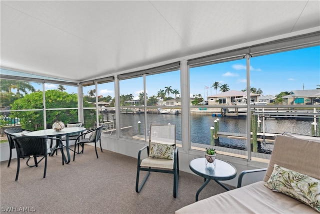 sunroom / solarium with a water view