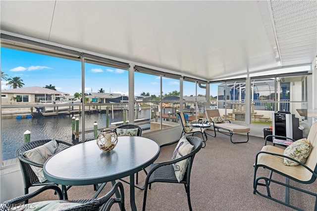 sunroom / solarium featuring a water view