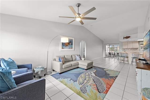 living room featuring ceiling fan, light tile patterned flooring, and vaulted ceiling