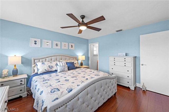 bedroom with dark hardwood / wood-style flooring and ceiling fan