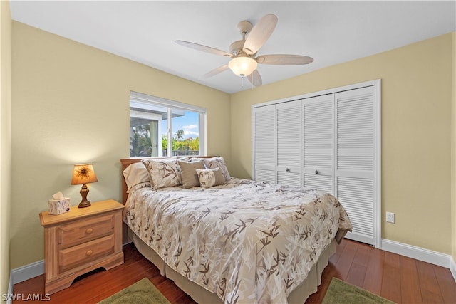 bedroom with dark hardwood / wood-style floors, ceiling fan, and a closet