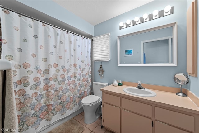 bathroom featuring tile patterned floors, vanity, and toilet