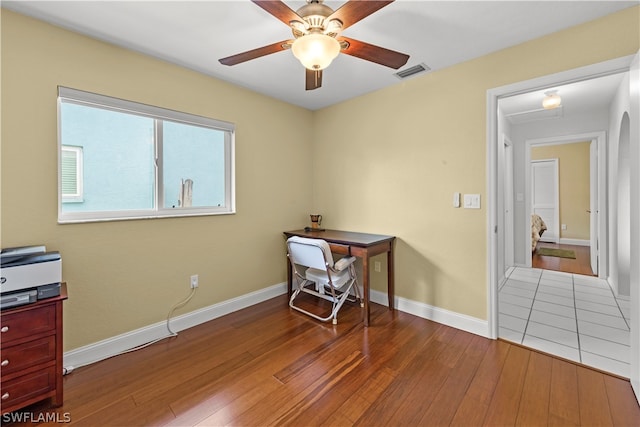 home office featuring wood-type flooring and ceiling fan