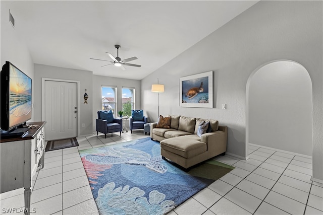 living room with ceiling fan, light tile patterned floors, and lofted ceiling