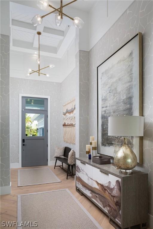 foyer featuring hardwood / wood-style floors and an inviting chandelier