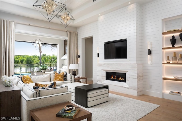 living room with light hardwood / wood-style floors and a premium fireplace