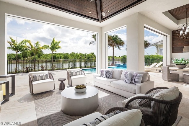 view of patio featuring an outdoor hangout area, a water view, and a fenced in pool