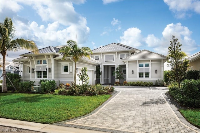 view of front facade with a front lawn and a garage