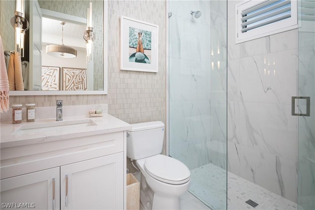 bathroom featuring toilet, vanity, and walk in shower