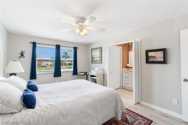 bedroom with ensuite bath, light wood-type flooring, and ceiling fan