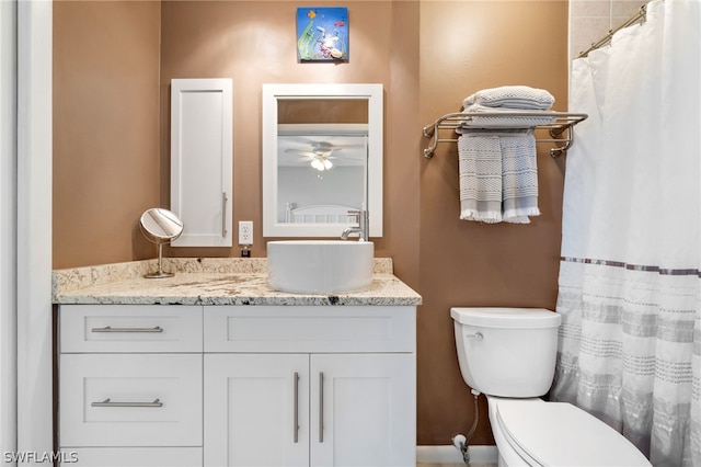 bathroom featuring ceiling fan, vanity, and toilet