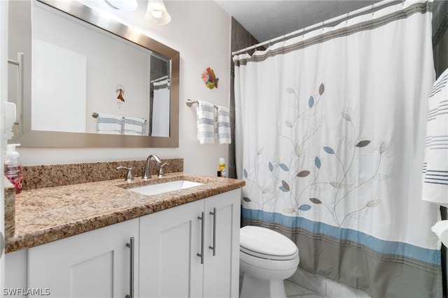 bathroom featuring curtained shower, vanity, and toilet