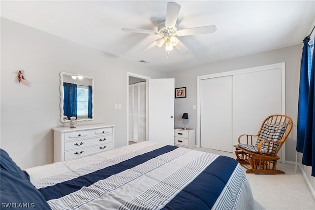 bedroom with ceiling fan, a closet, and carpet floors