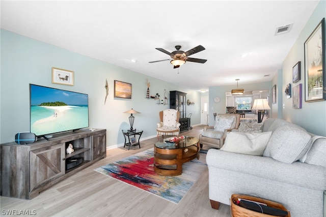 living room featuring ceiling fan and light wood-type flooring