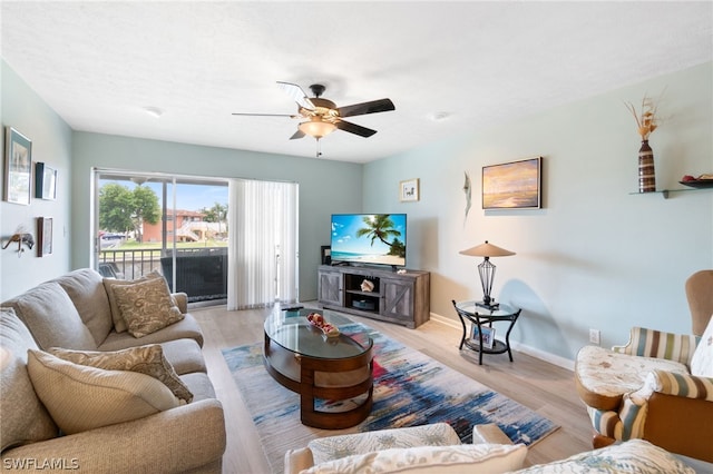 living room with light wood-type flooring and ceiling fan