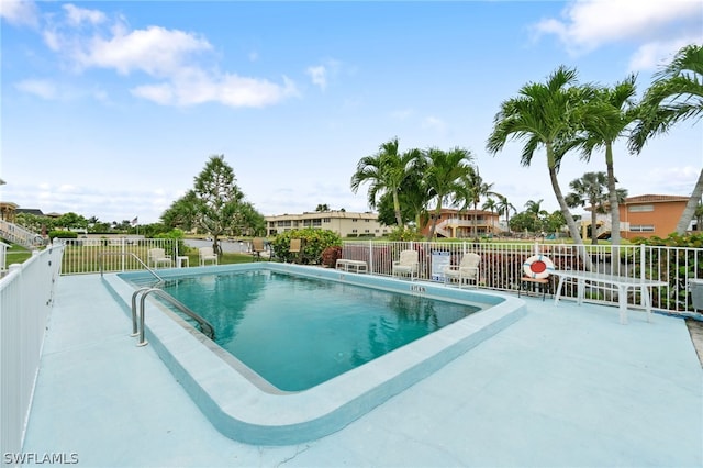 view of swimming pool with a patio