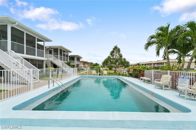 view of swimming pool with a sunroom