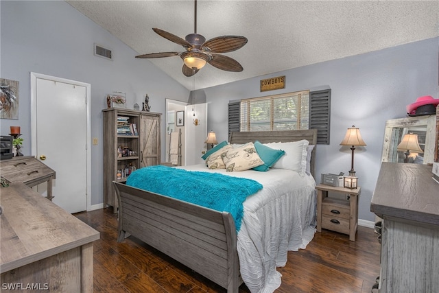 bedroom featuring a textured ceiling, ceiling fan, dark wood-type flooring, and vaulted ceiling